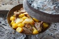 Lamb with potato in SaÃÂ sach, traditional metal cookware